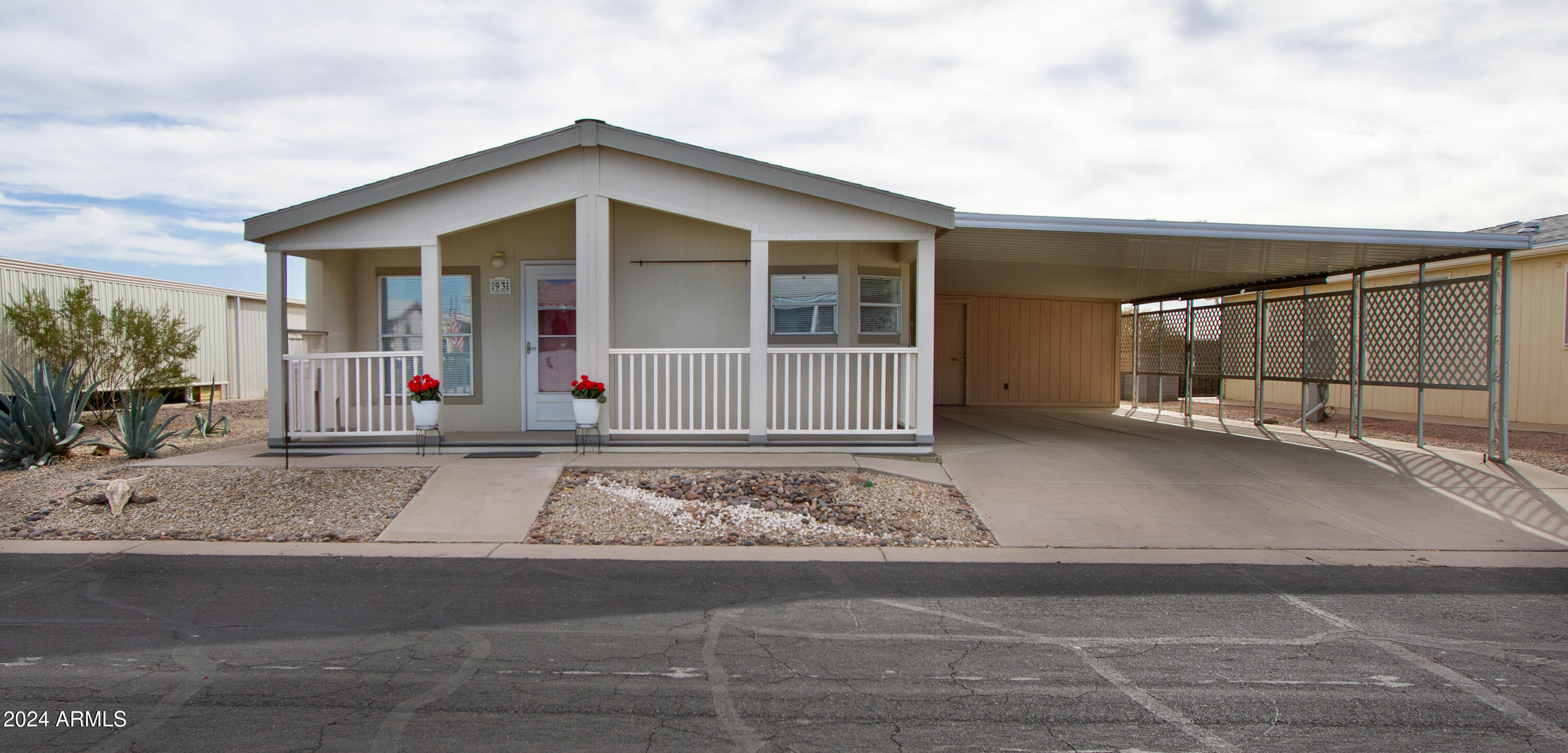 3700 South Tomahawk Road, Unit 93 Apache Junction, AZ 85119 - Photo 2 of 40 a front view of a house with a yard