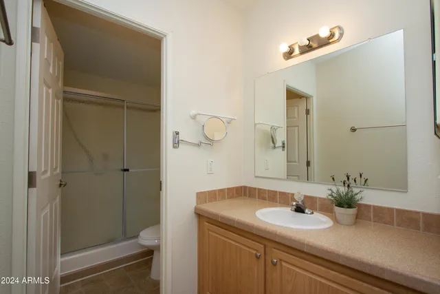 a bedroom with bed and cabinets