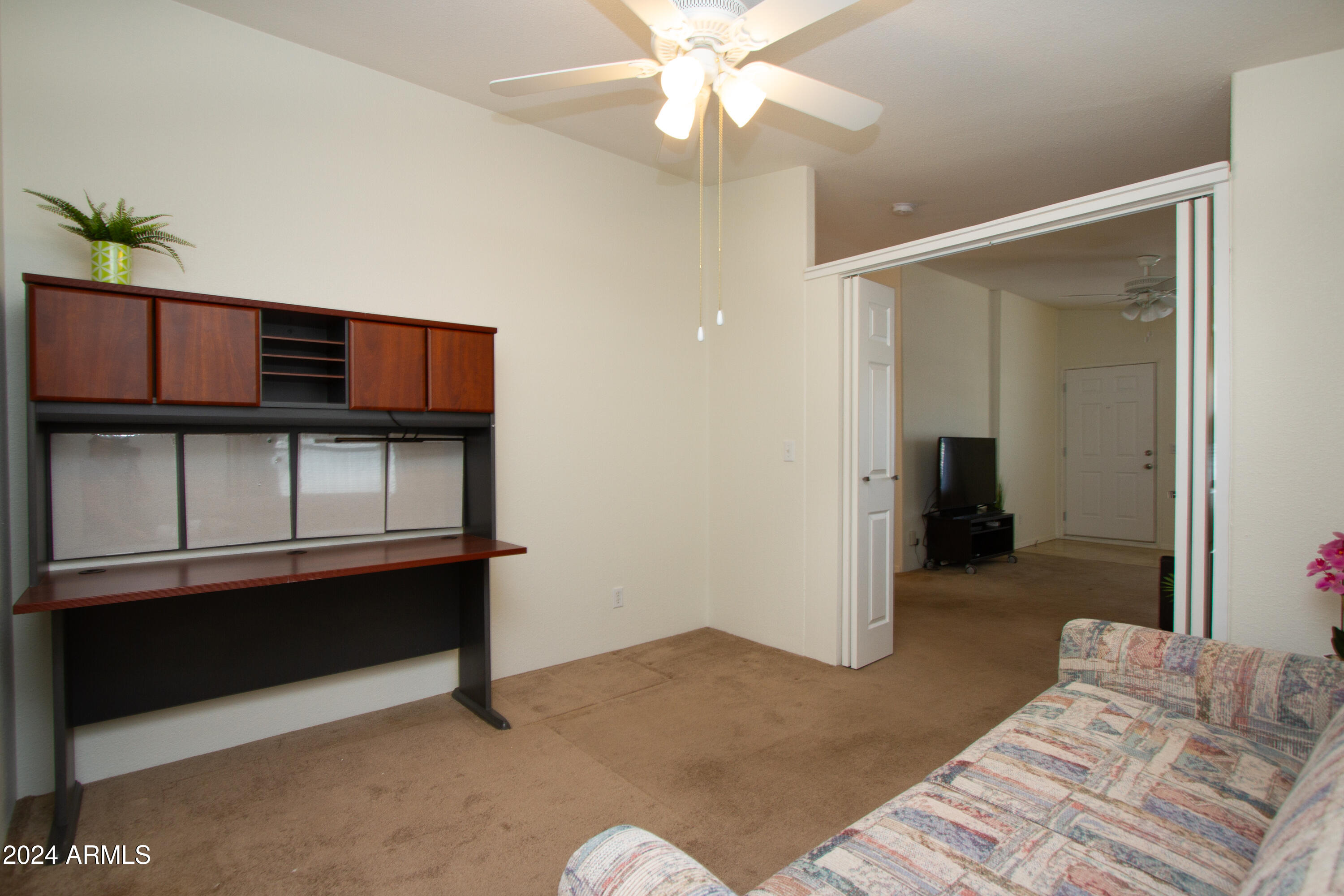 3700 South Tomahawk Road, Unit 93 Apache Junction, AZ 85119 - Photo 27 of 40 a bedroom with bed and cabinets