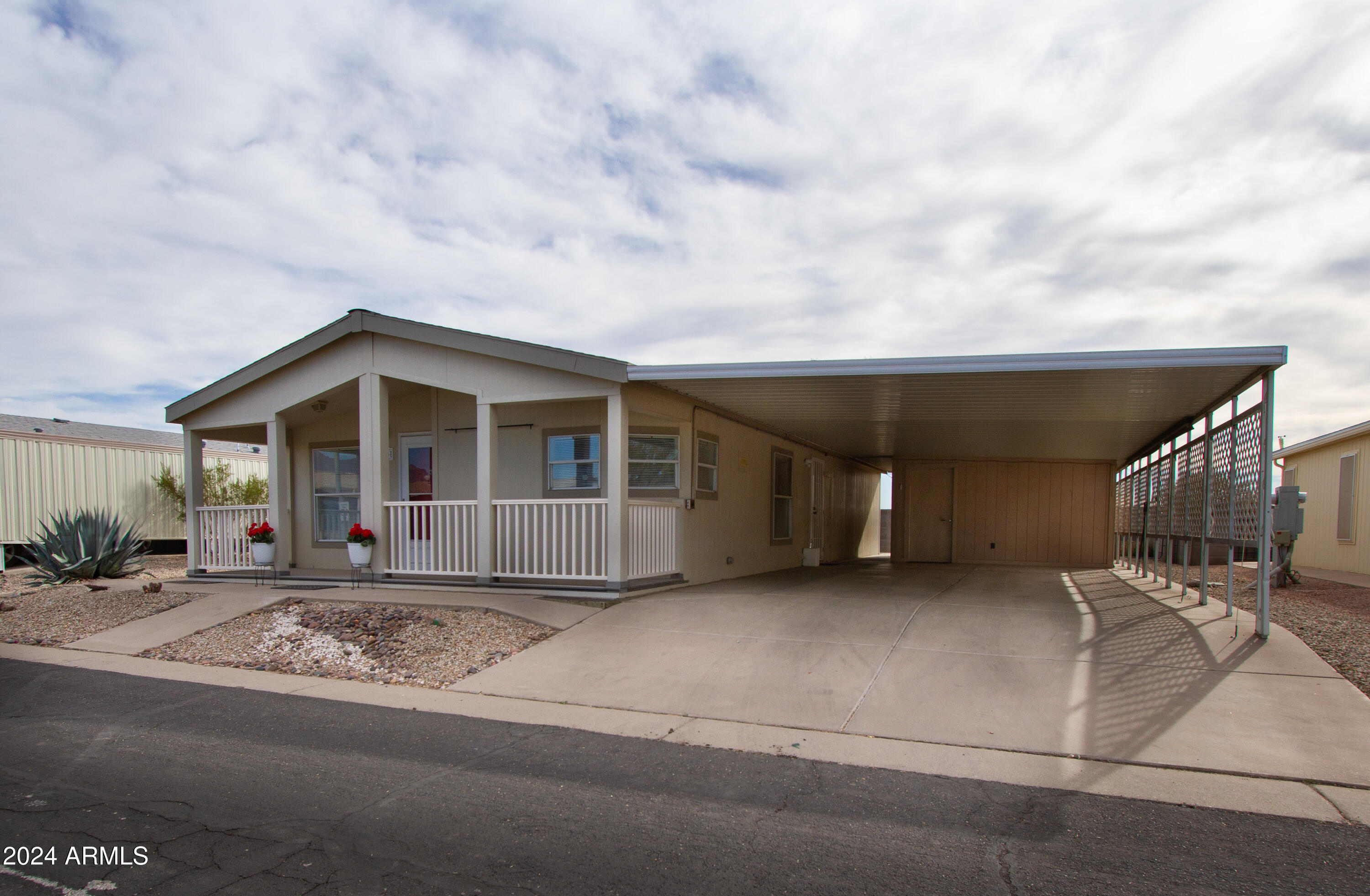 3700 South Tomahawk Road, Unit 93 Apache Junction, AZ 85119 - Photo 3 of 40 a front view of a house with garage