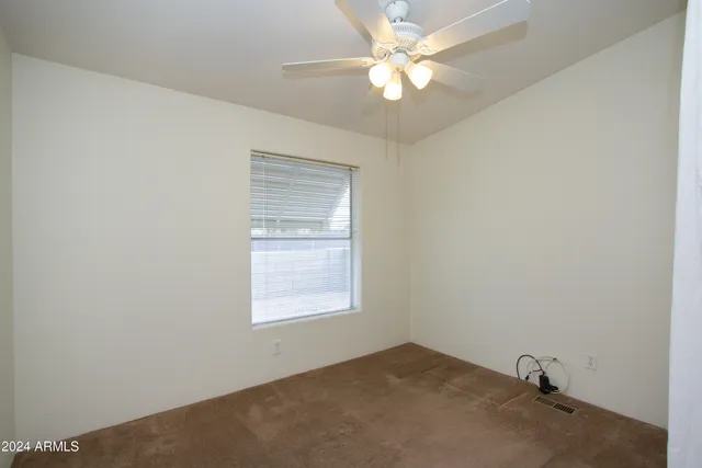 a view of an empty room with a fan