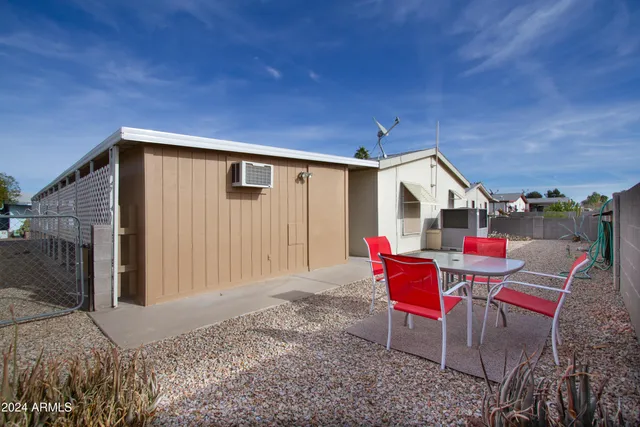a backyard of a house with a table and chairs