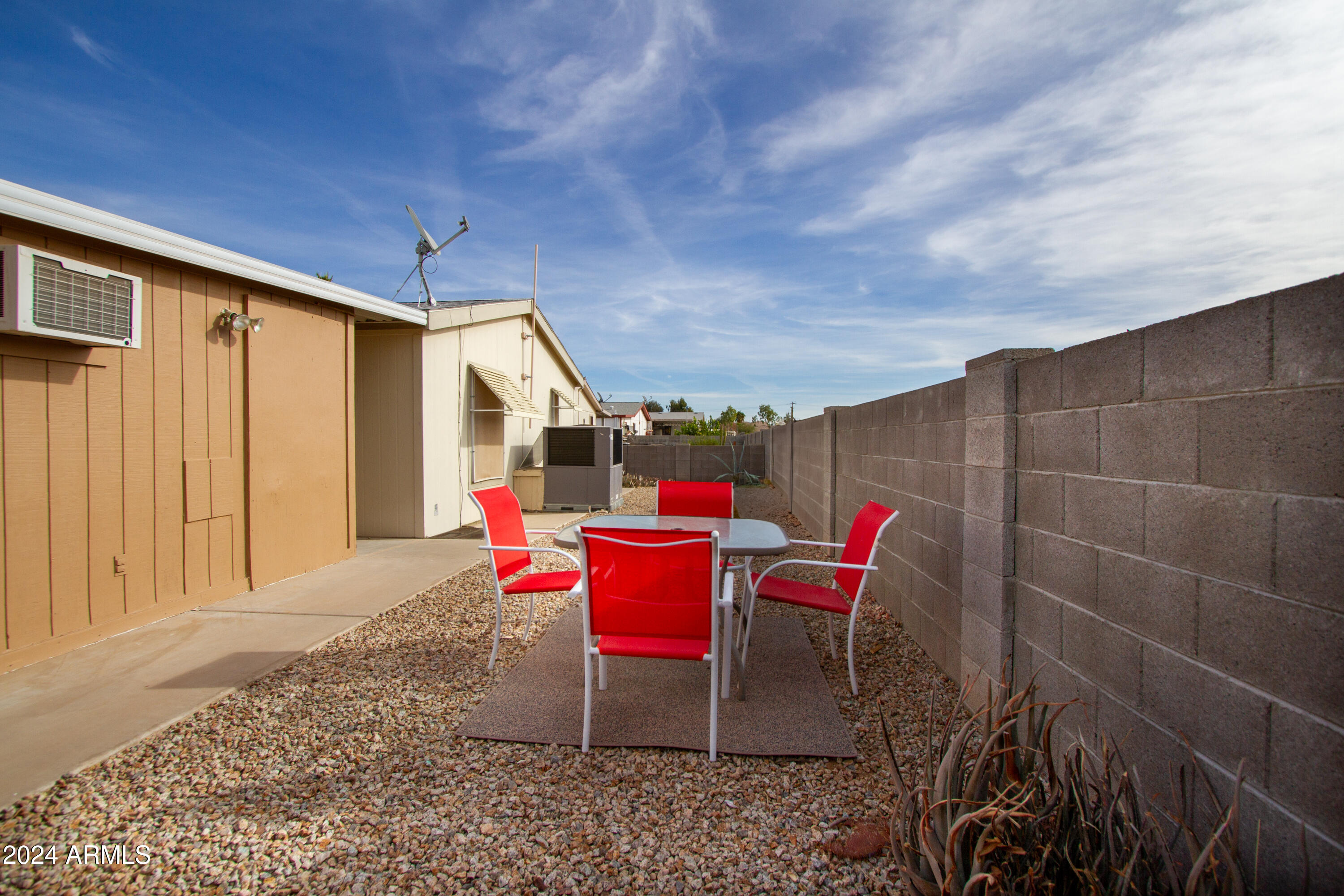 3700 South Tomahawk Road, Unit 93 Apache Junction, AZ 85119 - Photo 37 of 40 a backyard of a house with a table and chairs