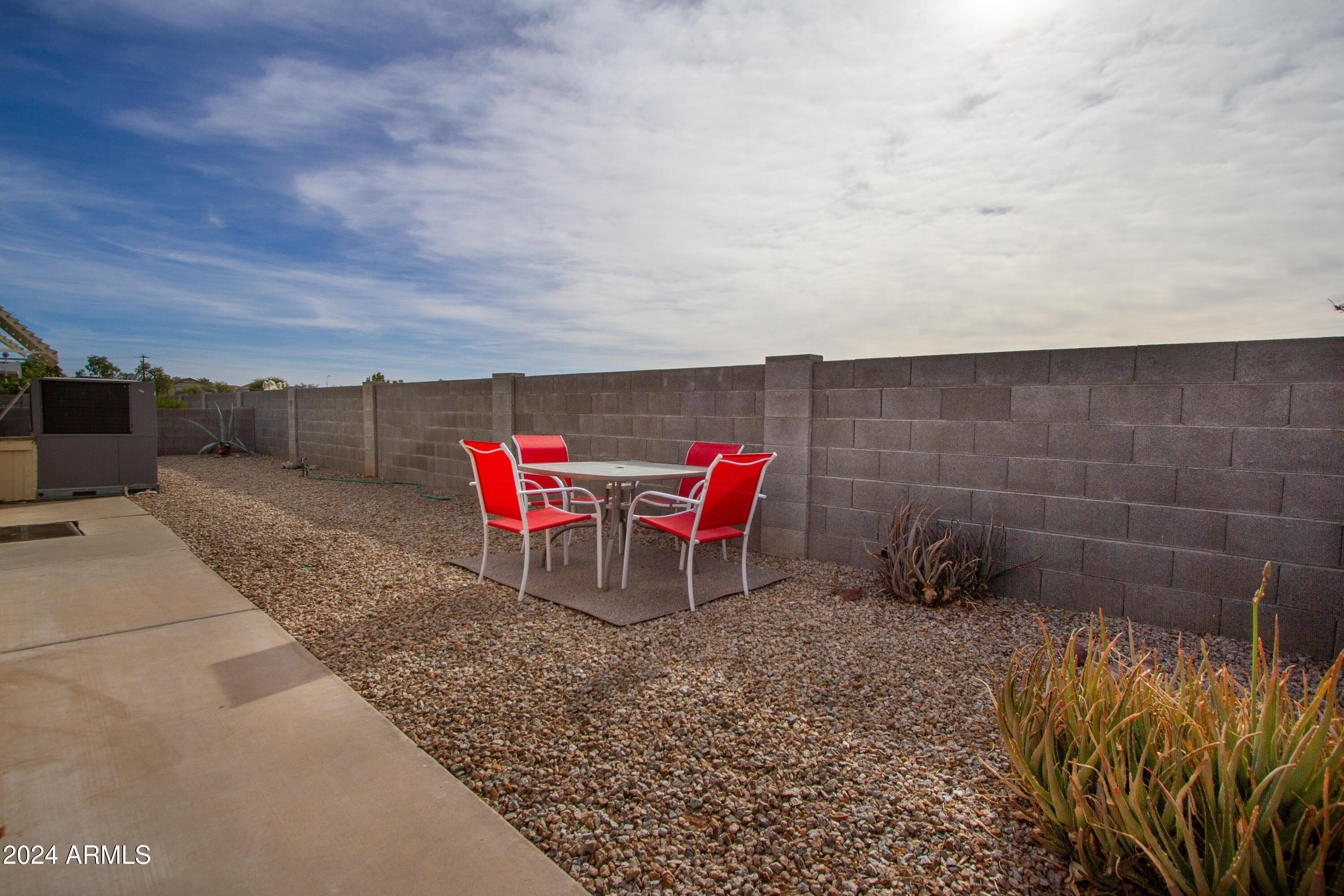 3700 South Tomahawk Road, Unit 93 Apache Junction, AZ 85119 - Photo 39 of 40 a lawn chairs sitting in a backyard of a house