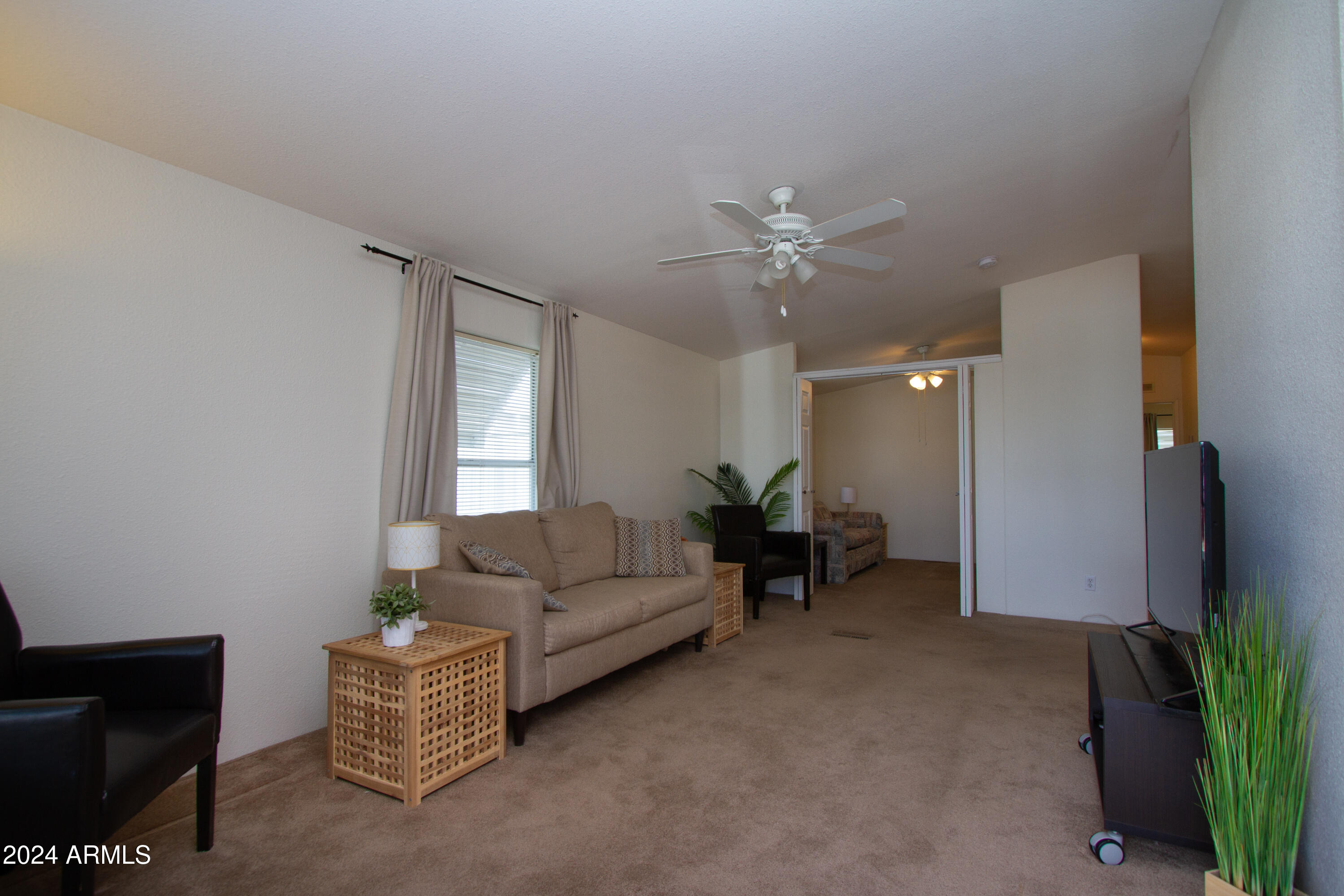 3700 South Tomahawk Road, Unit 93 Apache Junction, AZ 85119 - Photo 10 of 40 a living room with furniture and a chandelier
