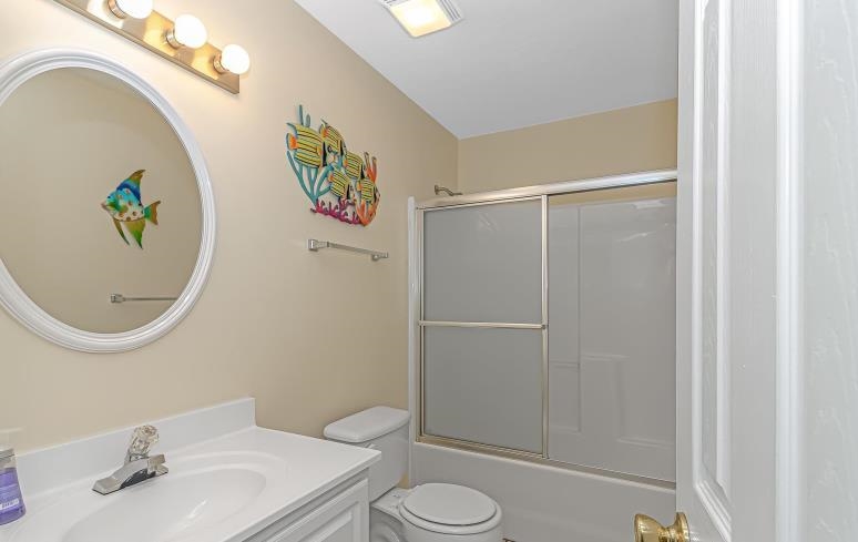 1171 Neptune Road Myrtle Beach, SC 29577 - Photo 13 of 29 Bathroom featuring vanity and shower / bath combination with glass door