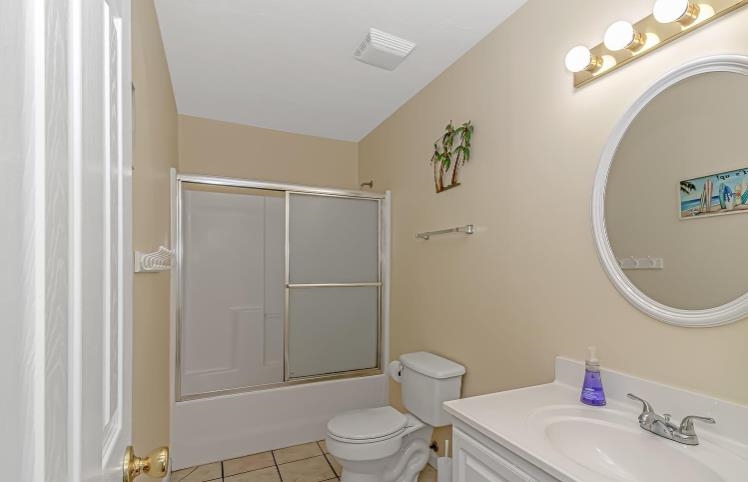 1171 Neptune Road Myrtle Beach, SC 29577 - Photo 14 of 29 Bathroom featuring vanity, light tile patterned flooring, and enclosed tub / shower combo