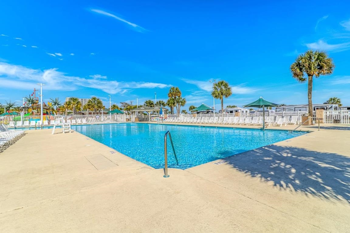 1171 Neptune Road Myrtle Beach, SC 29577 - Photo 26 of 29 Community pool featuring a patio