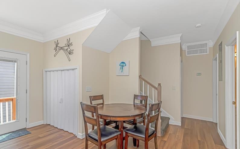 1171 Neptune Road Myrtle Beach, SC 29577 - Photo 6 of 29 Dining room featuring ornamental molding, stairs, and light wood finished floors