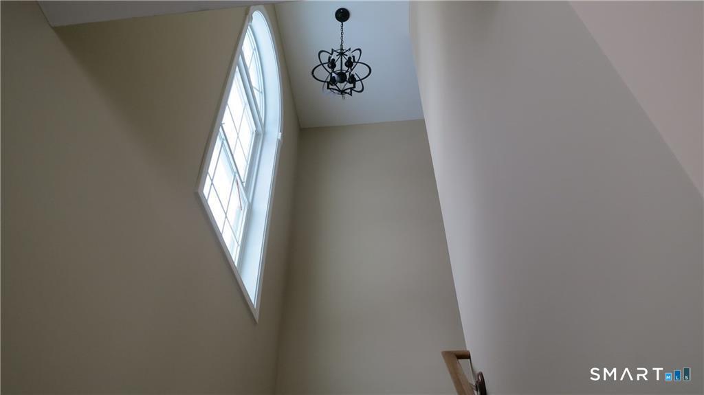823 A Stone Road Windsor, CT 06095 - Photo 23 of 38 Second story staircase with volume ceiling heights and palladian window for streaming light