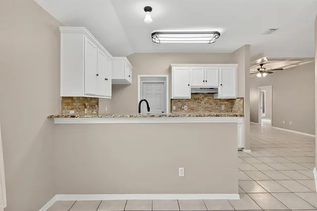 a kitchen with a sink cabinets and window