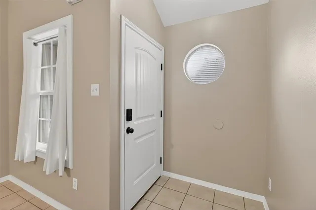 a view of a room with wooden floor and white walls