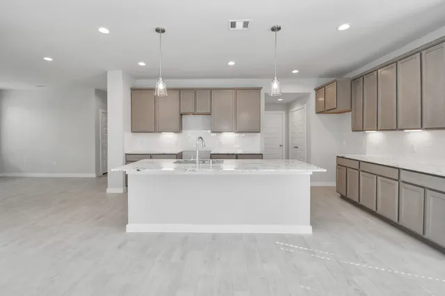 an empty room with windows and fireplace