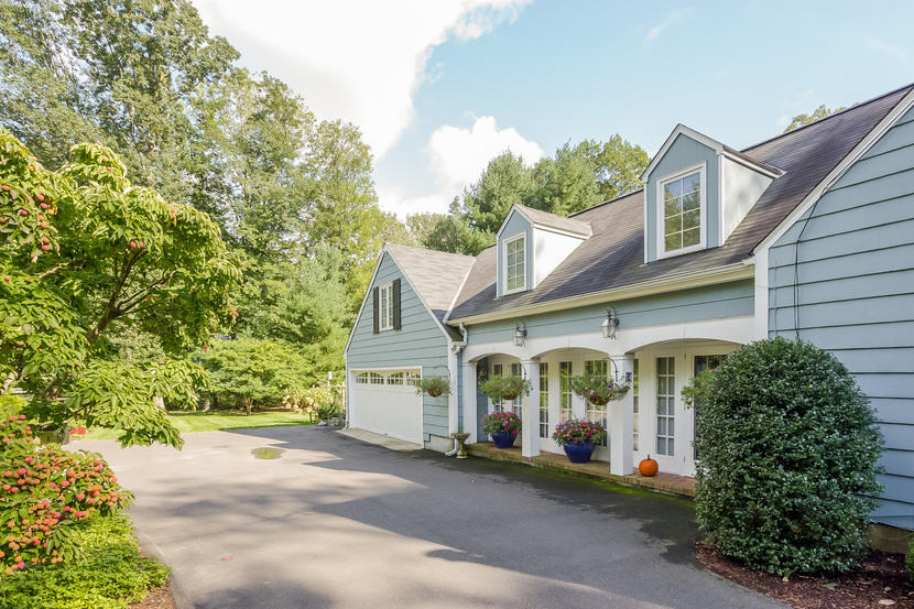 14 Meadowbrook Road Darien, CT 06820 - Photo 3 of 40 a view of a white house with large windows and a small yard
