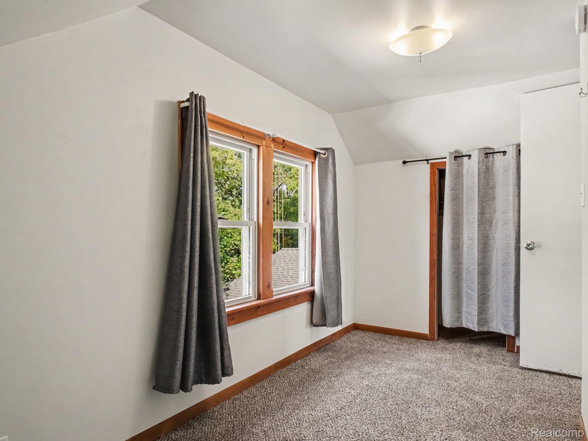 2840 Miller Road Flint, MI 48503 - Photo 36 of 49 Carpeted flooring, white walls, two windows with wood trim, and a ceiling-mounted light fixture