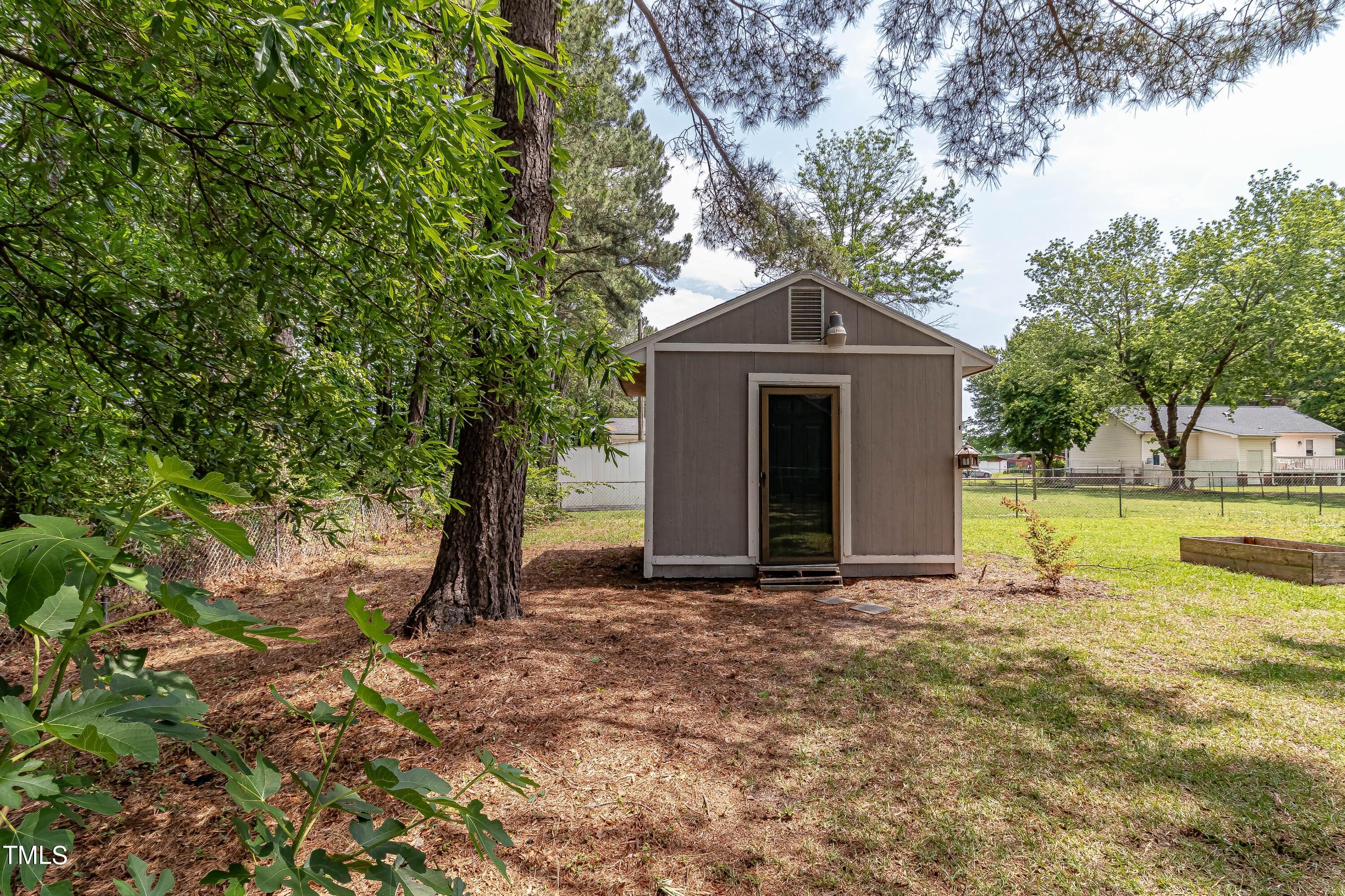410 Barbour Road Smithfield, NC 27577 - Photo 14 of 16 a front view of a house with a yard and large tree
