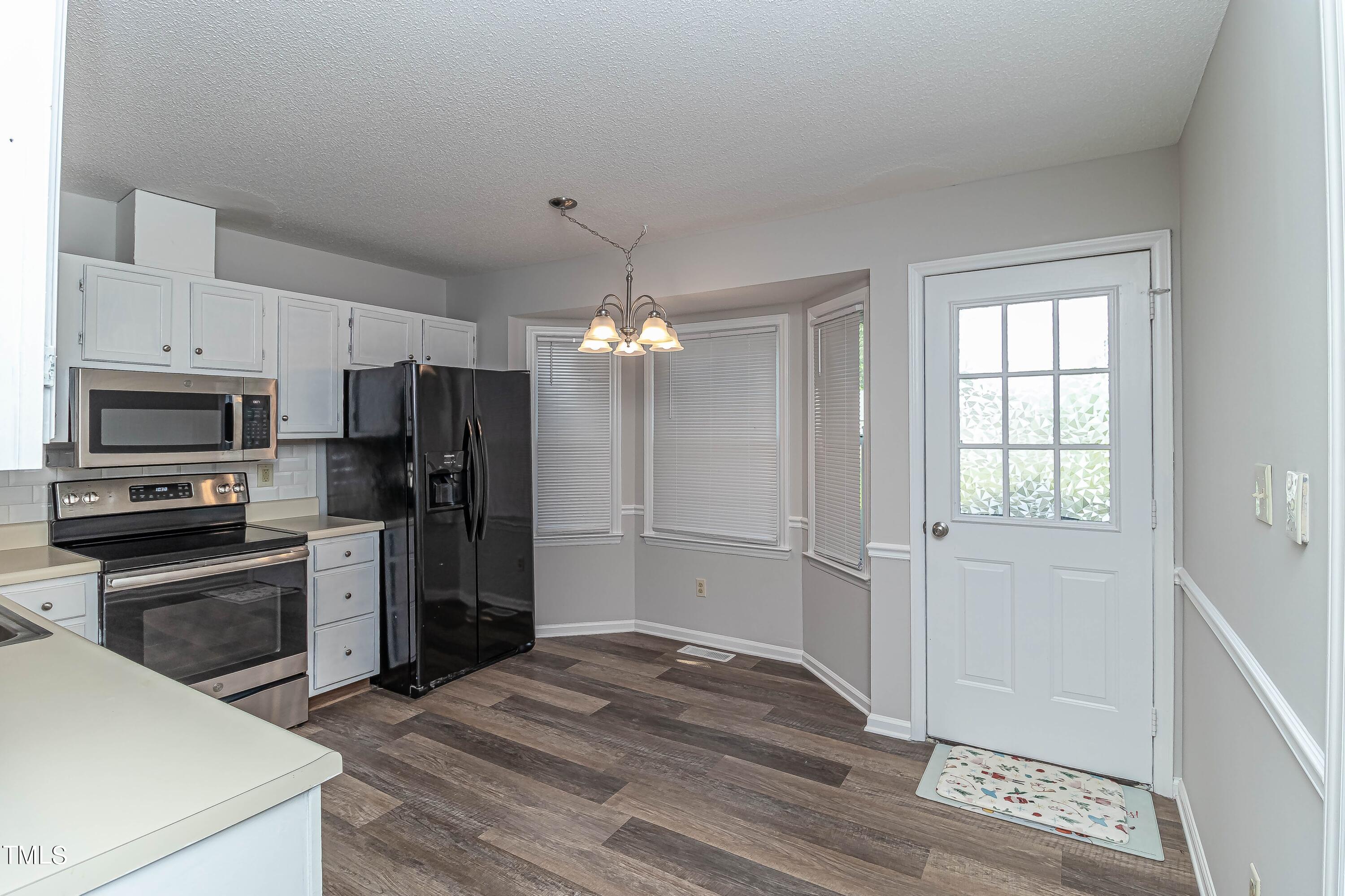 410 Barbour Road Smithfield, NC 27577 - Photo 4 of 16 a kitchen with a refrigerator oven a sink and dishwasher