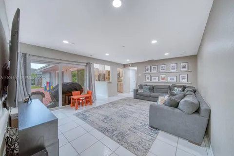 a living room with furniture and large windows