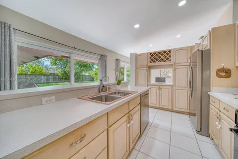a kitchen with a sink and refrigerator