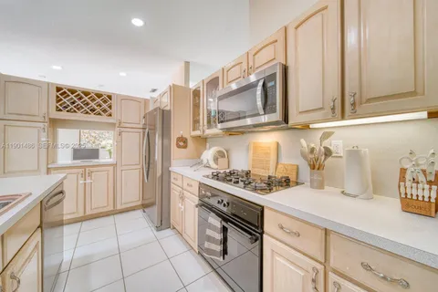 a kitchen with stainless steel appliances granite countertop a stove and a sink
