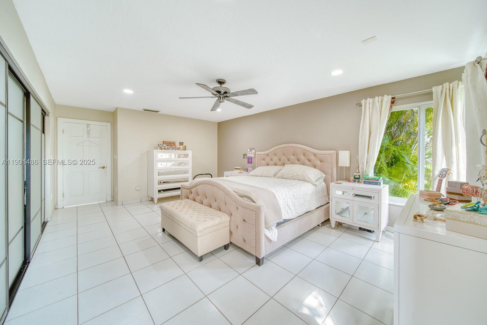10860 Southwest 124th Road Miami, FL 33176 - Photo 16 of 47 a spacious bedroom with a bed and a chandelier