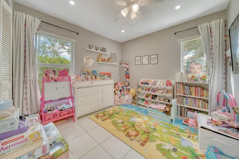 a bedroom with a bed and a bookshelf in it