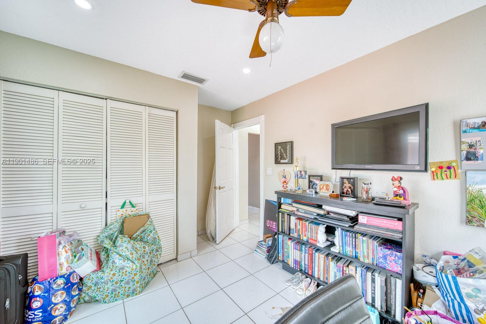 10860 Southwest 124th Road Miami, FL 33176 - Photo 24 of 47 a living room with furniture and a flat screen tv