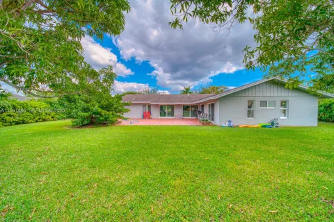 a view of an house with backyard space and garden