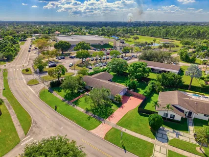 an aerial view of residential houses with outdoor space and street view