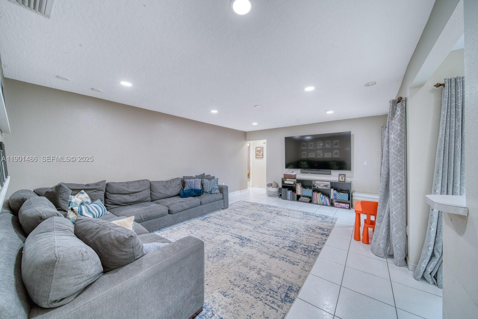 10860 Southwest 124th Road Miami, FL 33176 - Photo 10 of 47 a living room with furniture and a flat screen tv