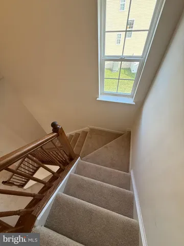 a view of room with window and wooden floor