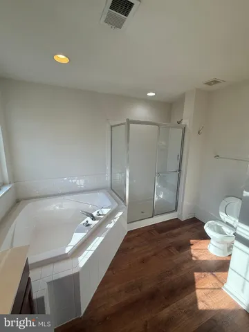 a bathroom with a tub a sink and mirror