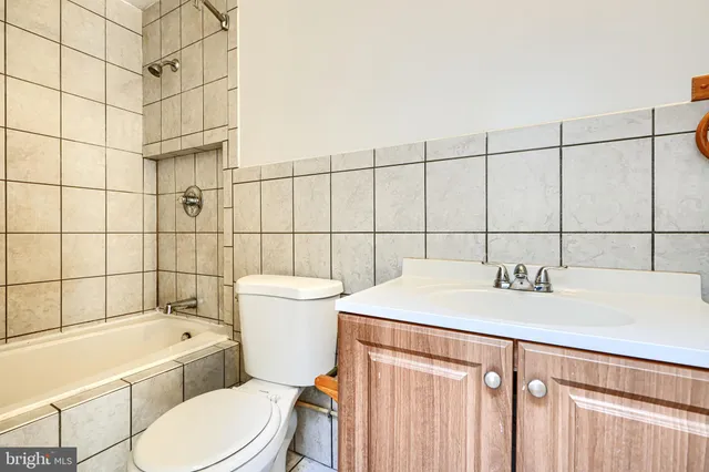 a bathroom with a sink a toilet and bathtub