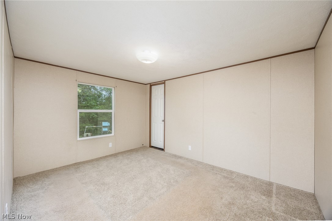 7455 Stanleyville Road Whipple, OH 45788 - Photo 26 of 37 Carpeted room featuring a single window and a white interior door