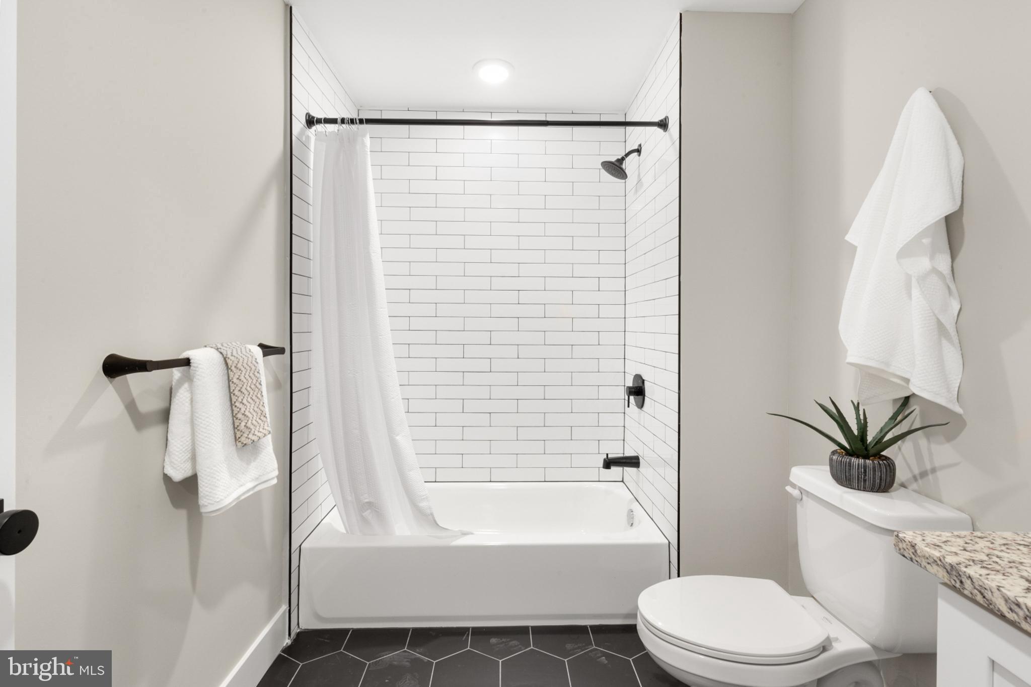 1924 North Front Street, Unit 305 Philadelphia, PA 19122 - Photo 15 of 30 a bathroom with a toilet a sink and bathtub