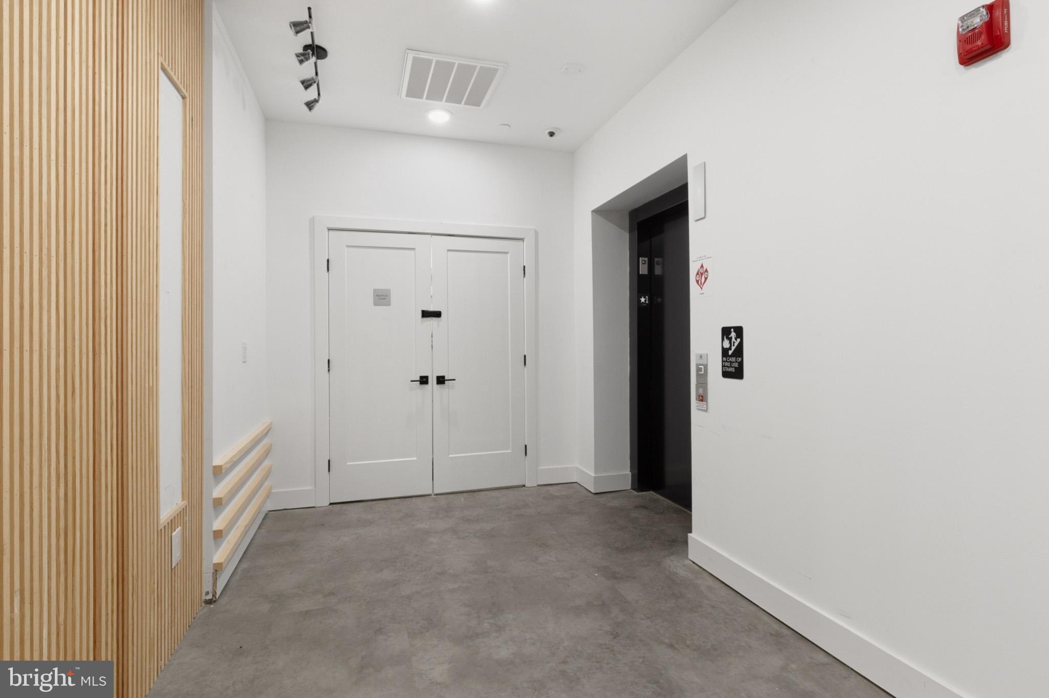 1924 North Front Street, Unit 305 Philadelphia, PA 19122 - Photo 27 of 30 a view of a hallway with wooden shelves