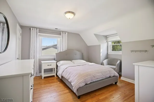 a bedroom with a bed a mirror and a desk