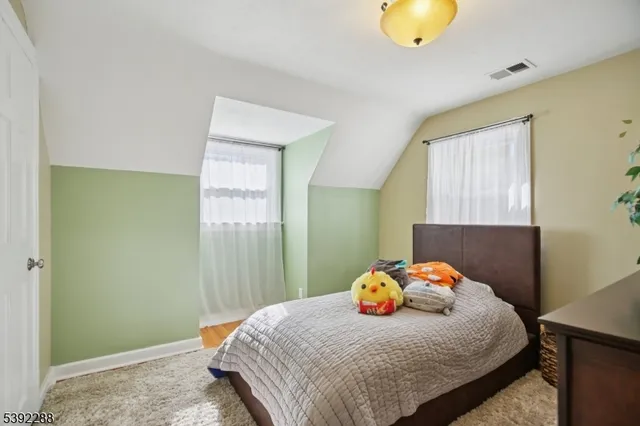 a bedroom with a bed and teddy bear