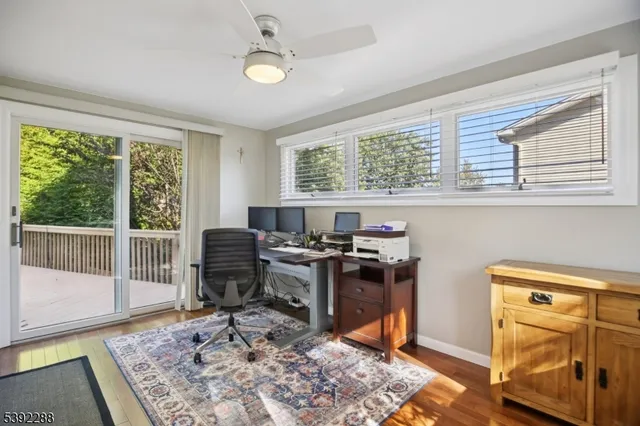 a view of a workspace with furniture and a window