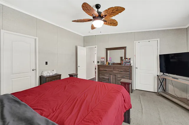 a bed room with a bed and a television