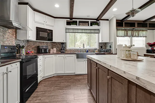 a kitchen with a sink stove and microwave