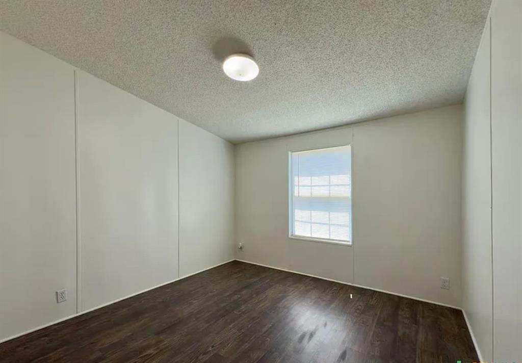 375 Alto Lane Gholson, TX 76705 - Photo 14 of 15 an empty room with wooden floor and windows