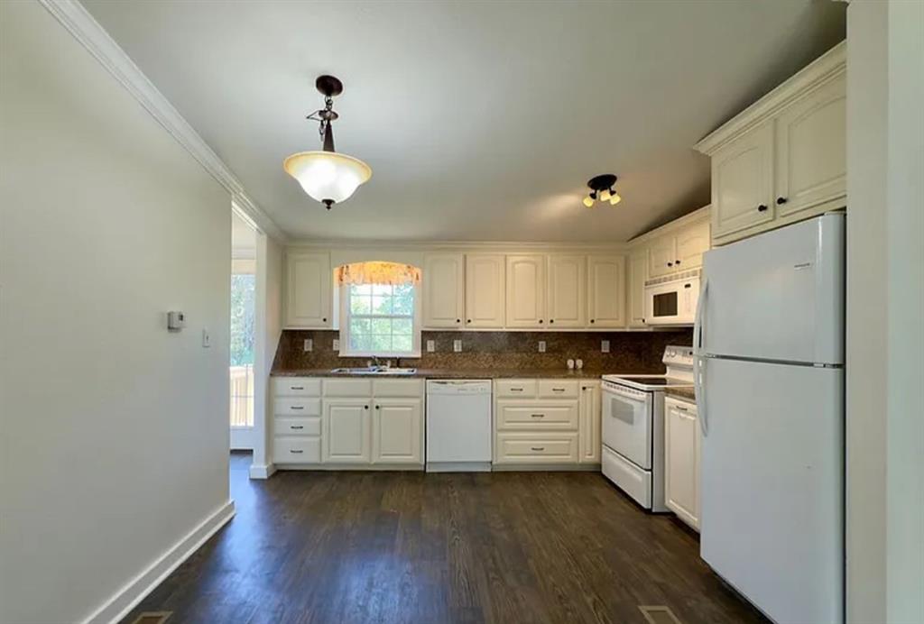 375 Alto Lane Gholson, TX 76705 - Photo 4 of 15 a kitchen with granite countertop a refrigerator a sink dishwasher a stove and white cabinets with wooden floor
