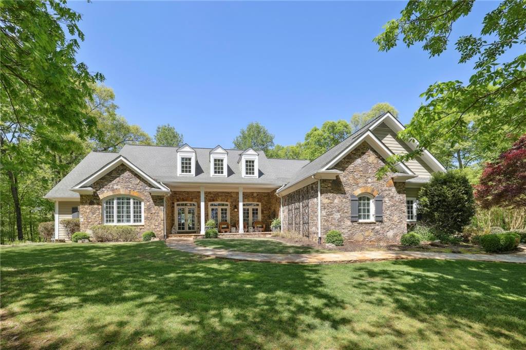 1390 Summit Road Milton, GA 30004 - Photo 1 of 1 a front view of a house with a garden