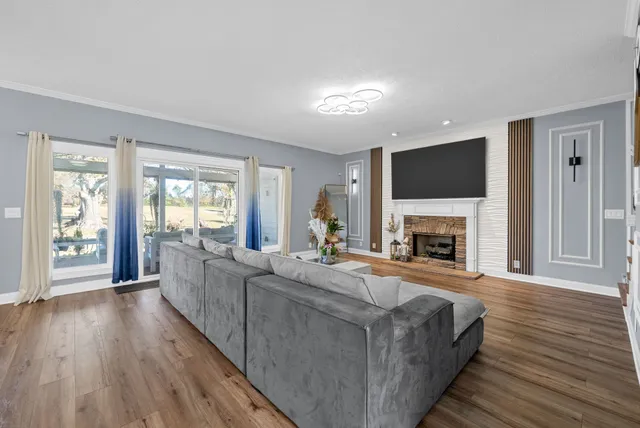 a living room with a fireplace and a flat screen tv