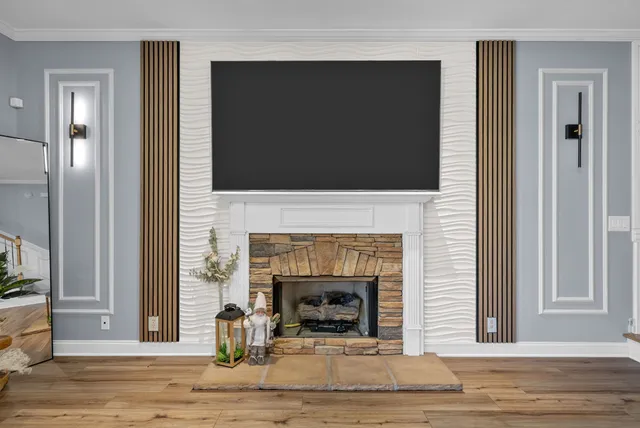 a living room with fireplace furniture and a flat screen tv