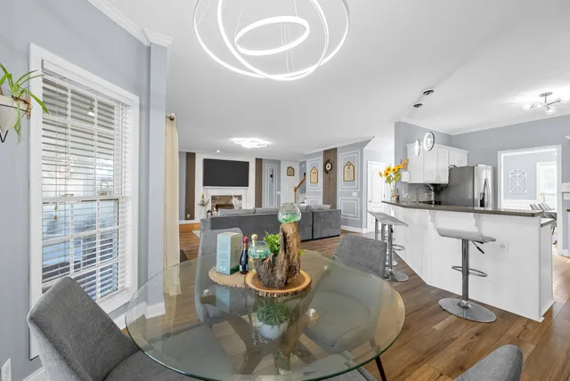 a kitchen with stainless steel appliances kitchen island granite countertop a stove a sink and a refrigerator