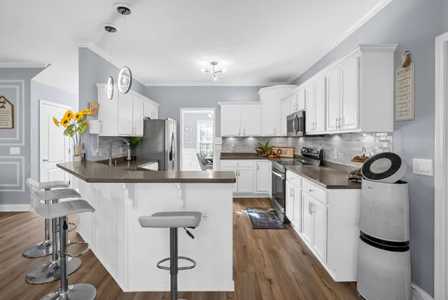a kitchen with white cabinets and white appliances