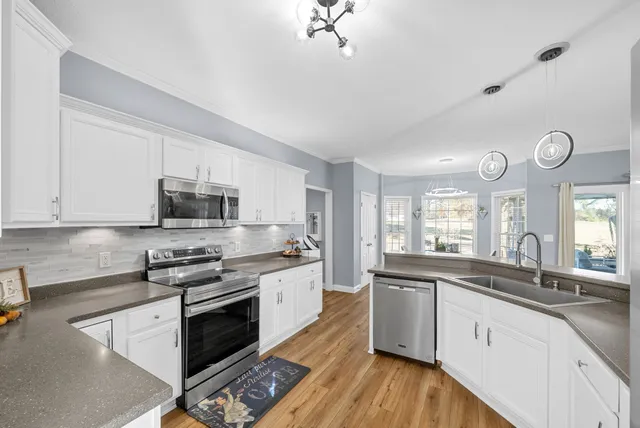 a bedroom with bed and a chandelier