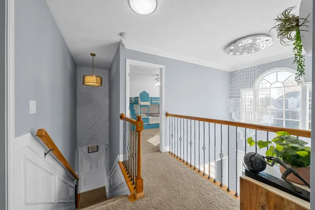 a spacious bedroom with a bed and a chandelier